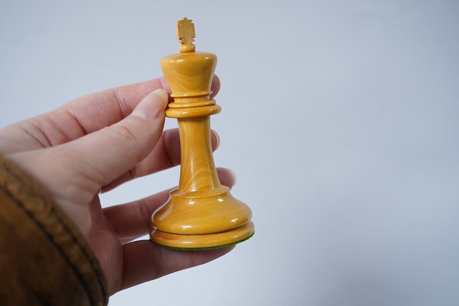 An early 20th century boxed J. Jaques & Son Staunton chess set, ebony and boxwood pieces, contained within the original velvet lined teak box with sliding lid and paper label to lid with facsimile of Howard Staunton sign